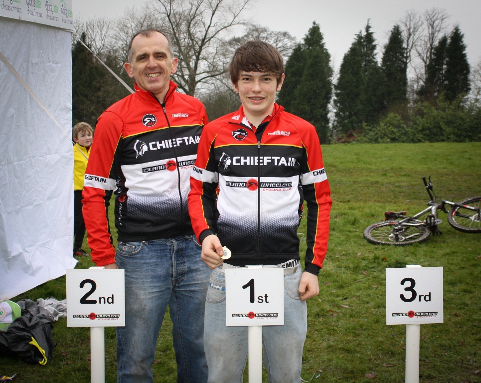 Conor Boyle receives his winners medal from Aidan Lafferty in the under 14 race.